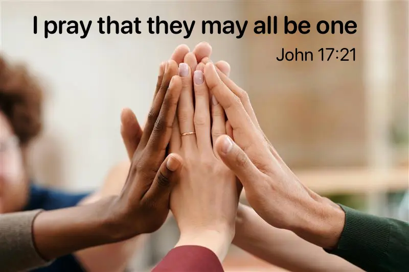 Image of multiple hands joined to make a tower shape, with the Bible text I pray that they may all be one (John 17:21)